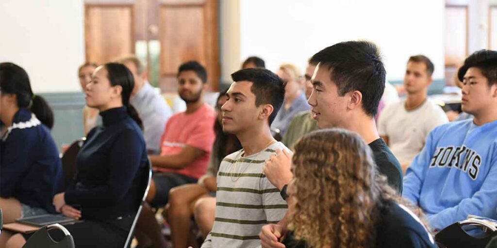 Kissinger students talking in class